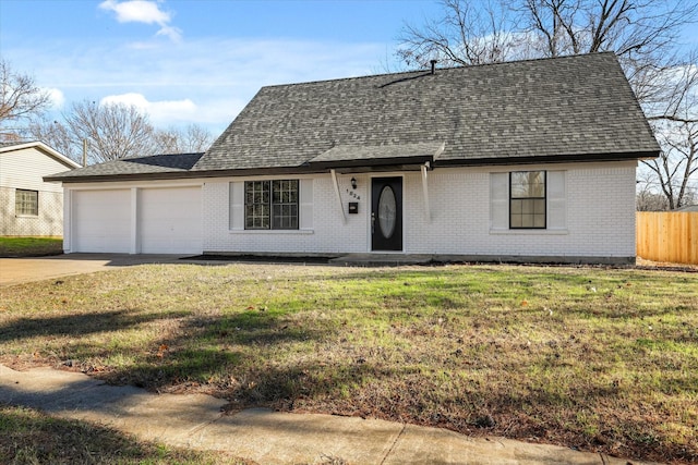 ranch-style home with a garage and a front lawn