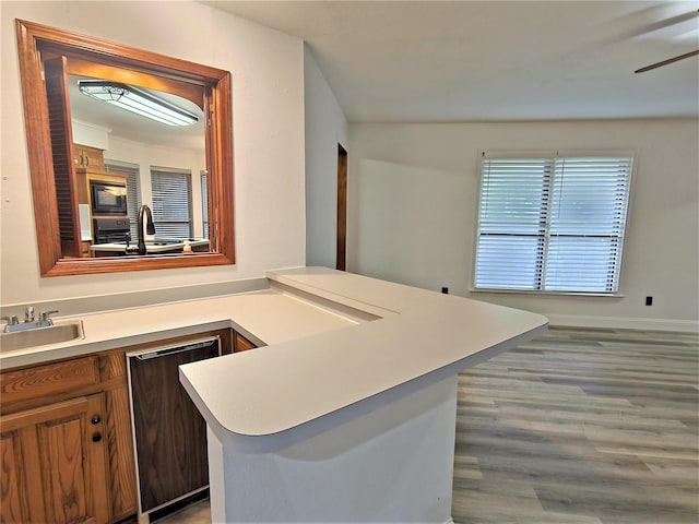 2735 Steamboat Cir, Arlington, TX 76006 - kitchen with dishwasher, built in microwave, light countertops, wood finished floors, and a sink