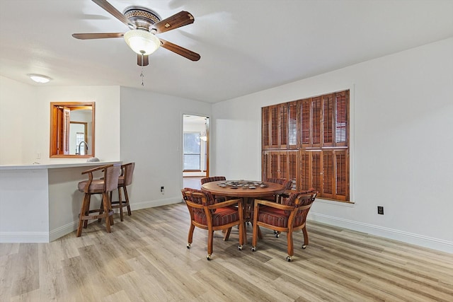 dining area with plenty of natural light, ceiling fan, and light wood-type flooring