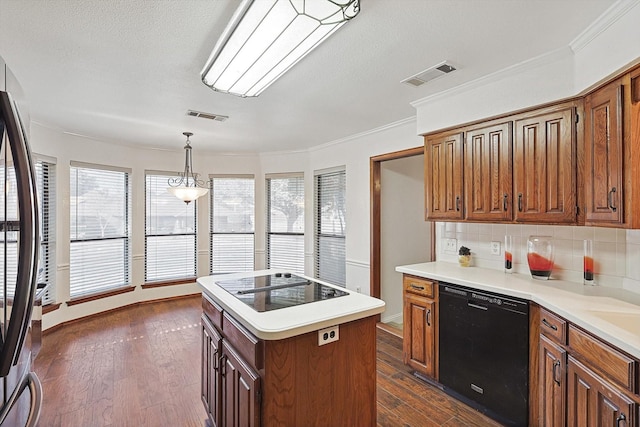 2735 Steamboat Cir, Arlington, TX 76006 - kitchen with black appliances, tasteful backsplash, dark wood-type flooring, a kitchen island, and light countertops