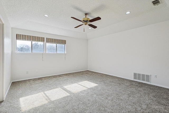 carpeted empty room with ceiling fan and a textured ceiling