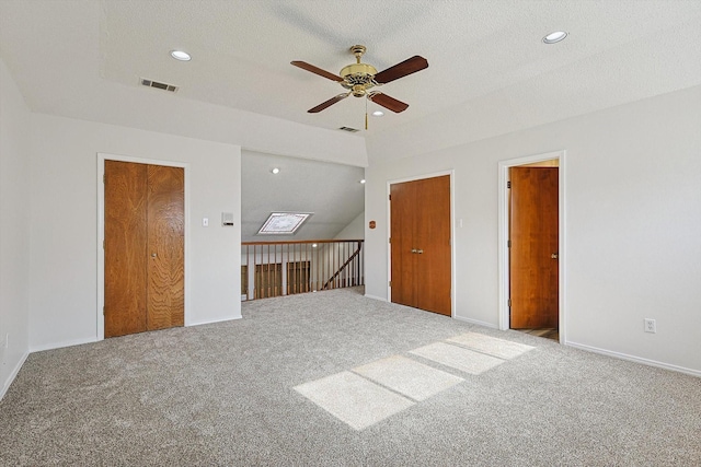 interior space with ceiling fan and a textured ceiling