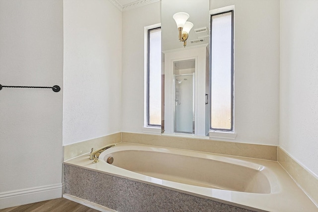 bathroom featuring wood-type flooring and a tub