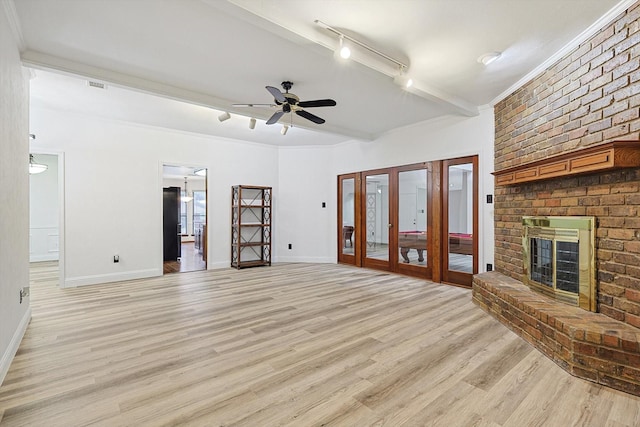 2735 Steamboat Cir, Arlington, TX 76006 - unfurnished living room with track lighting, light wood finished floors, a fireplace, ceiling fan, and baseboards