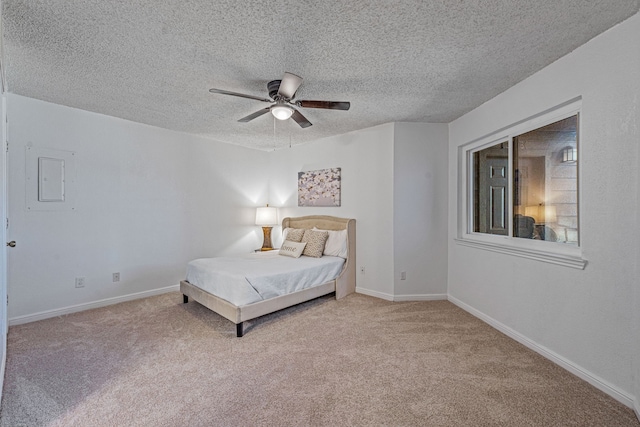 unfurnished bedroom with ceiling fan, carpet floors, and a textured ceiling