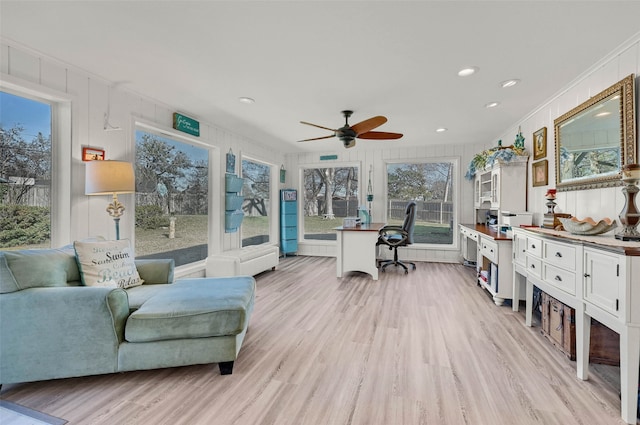 office space featuring ornamental molding, ceiling fan, and light hardwood / wood-style flooring