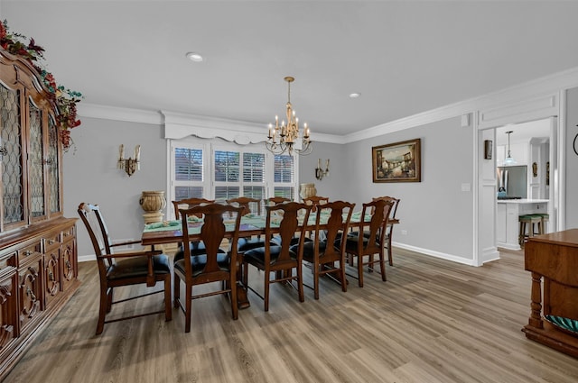 dining area with an inviting chandelier, ornamental molding, and wood-type flooring