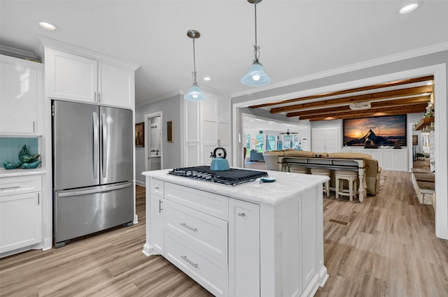 kitchen featuring white cabinetry, crown molding, pendant lighting, and appliances with stainless steel finishes