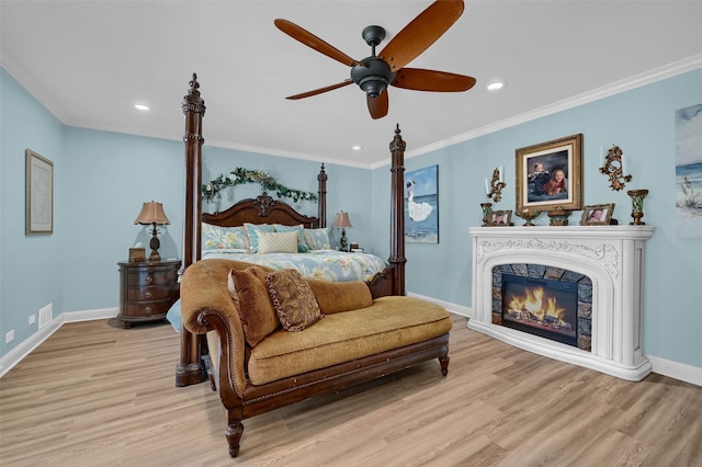 bedroom featuring crown molding, ceiling fan, and light hardwood / wood-style flooring