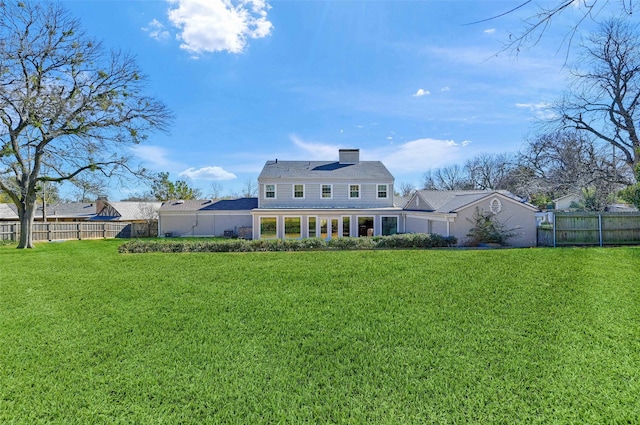 rear view of house with a lawn