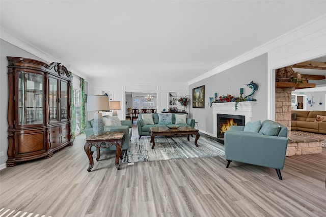 living room with ornamental molding, a chandelier, and light wood-type flooring