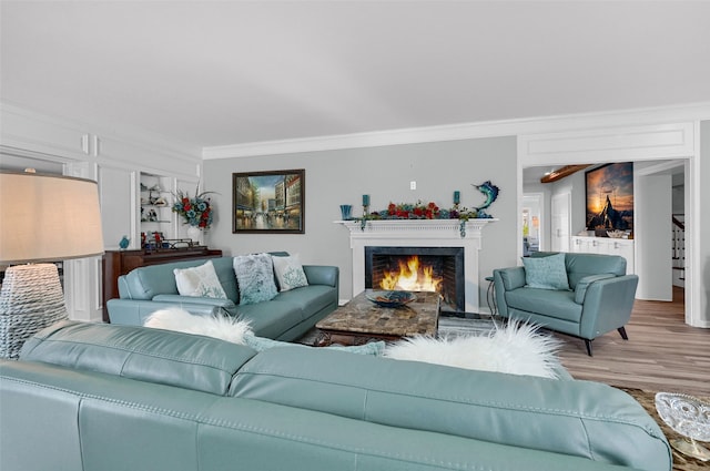 living room featuring hardwood / wood-style flooring and ornamental molding