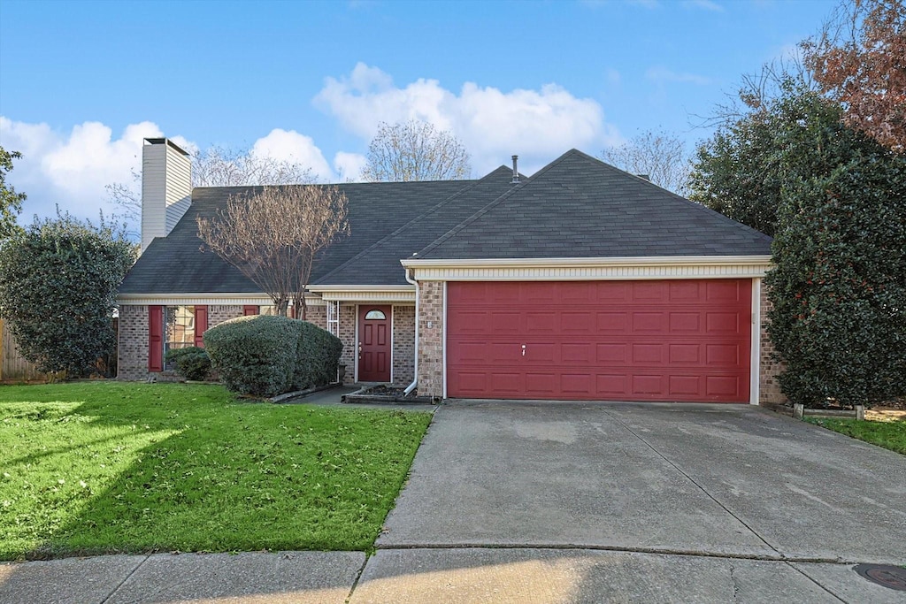 ranch-style house with a front yard and a garage