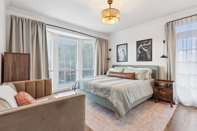 bedroom featuring hardwood / wood-style floors and ornamental molding