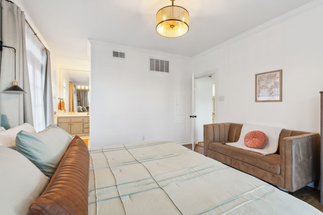 bedroom featuring hardwood / wood-style floors, ensuite bathroom, and ornamental molding