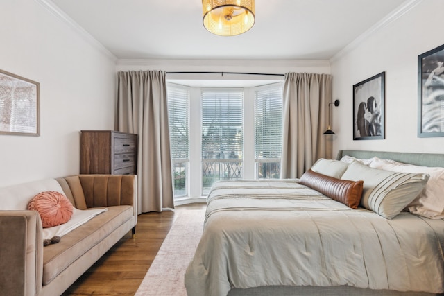 bedroom with light wood-type flooring and crown molding