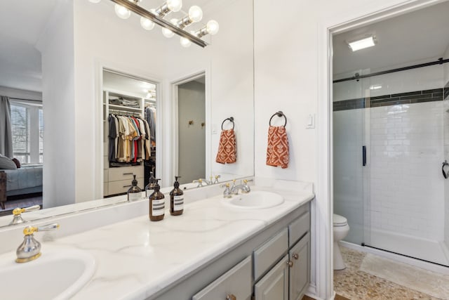 bathroom featuring vanity, toilet, and walk in shower