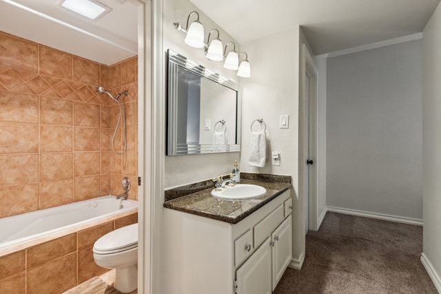 full bathroom with vanity, tiled shower / bath combo, and toilet