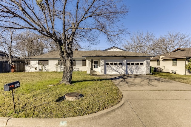 single story home featuring a garage and a front lawn