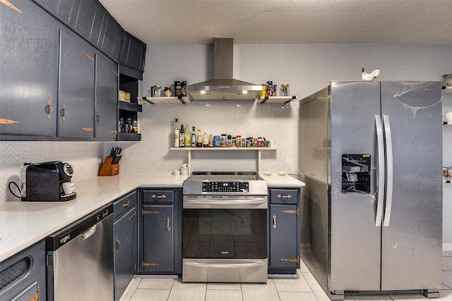 kitchen with light tile patterned flooring, wall chimney range hood, appliances with stainless steel finishes, and tasteful backsplash