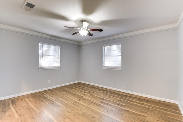 empty room featuring ceiling fan and hardwood / wood-style floors