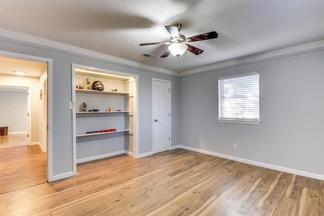 unfurnished bedroom with ceiling fan and light wood-type flooring