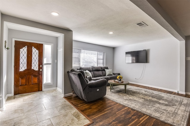 living room with hardwood / wood-style floors and a textured ceiling