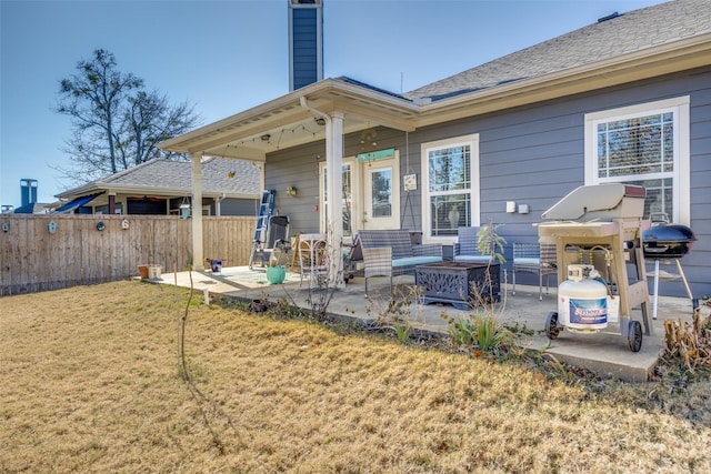 rear view of house featuring a patio area, a fire pit, and a yard