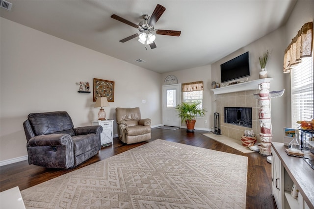 living room with ceiling fan, dark wood-type flooring, and a fireplace