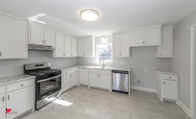 kitchen featuring white cabinetry, appliances with stainless steel finishes, light stone countertops, and sink