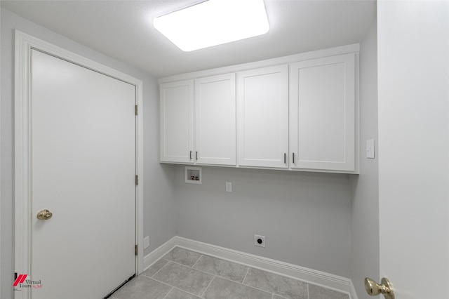 clothes washing area featuring cabinets, hookup for a washing machine, light tile patterned floors, and electric dryer hookup