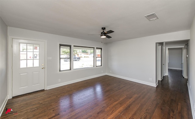 interior space with dark wood-type flooring and ceiling fan