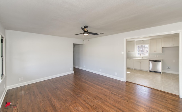 spare room featuring sink, light hardwood / wood-style floors, and ceiling fan