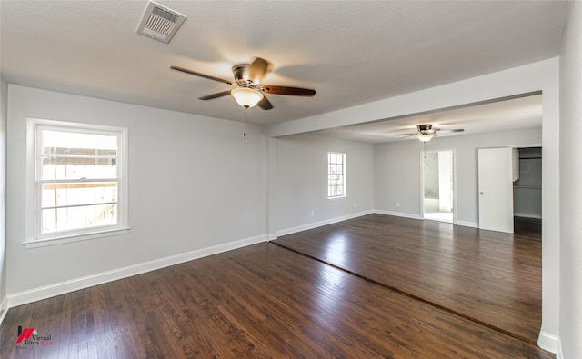 spare room with a textured ceiling, dark hardwood / wood-style floors, and ceiling fan