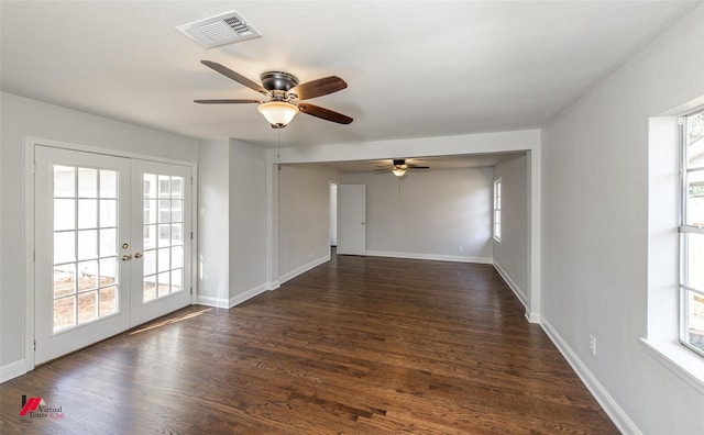 empty room with dark hardwood / wood-style floors, ceiling fan, and french doors