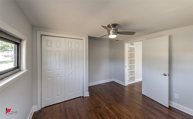 unfurnished bedroom featuring a closet, dark hardwood / wood-style floors, and ceiling fan