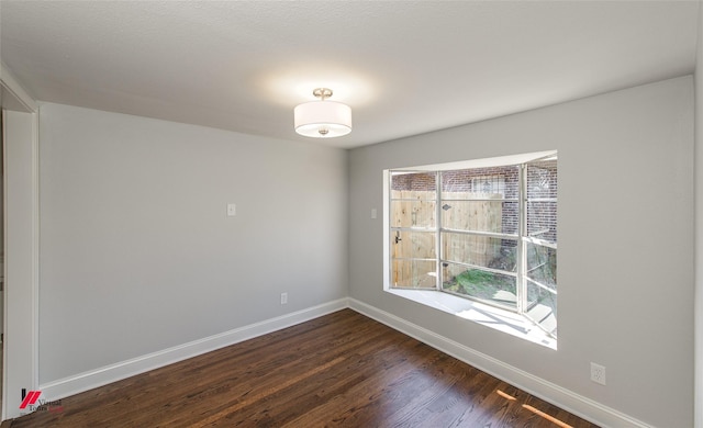 spare room with dark hardwood / wood-style floors