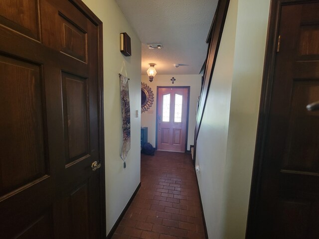 doorway with a textured ceiling