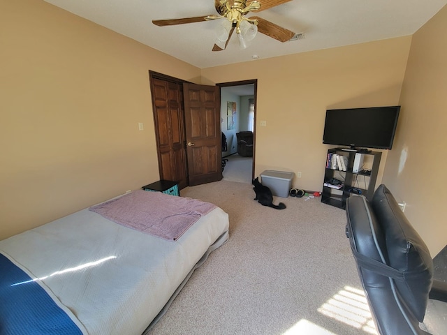 bedroom featuring ceiling fan and light colored carpet