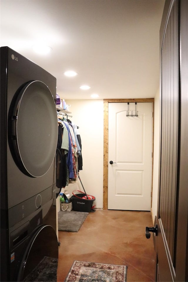 laundry area featuring stacked washing maching and dryer