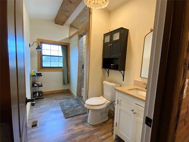 bathroom with hardwood / wood-style floors, vanity, a notable chandelier, toilet, and beam ceiling