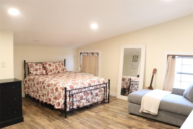 bedroom featuring lofted ceiling and hardwood / wood-style floors