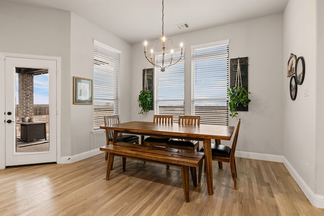 dining area with a chandelier and light hardwood / wood-style floors