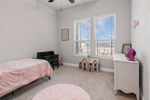 carpeted bedroom with ceiling fan and baseboards