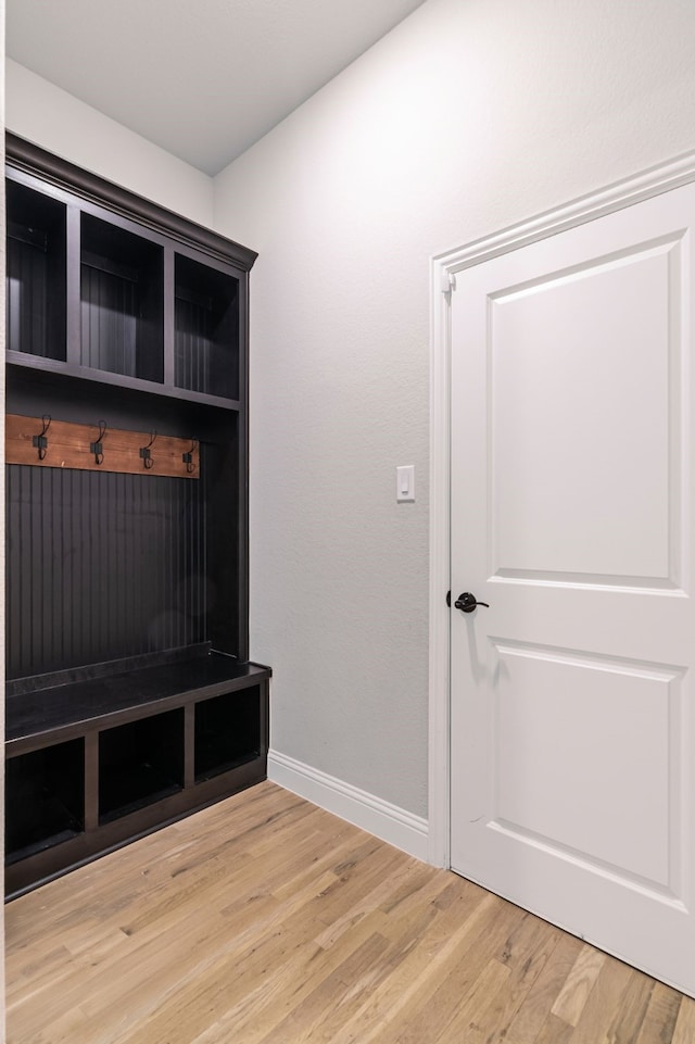 mudroom with light wood-style floors and baseboards