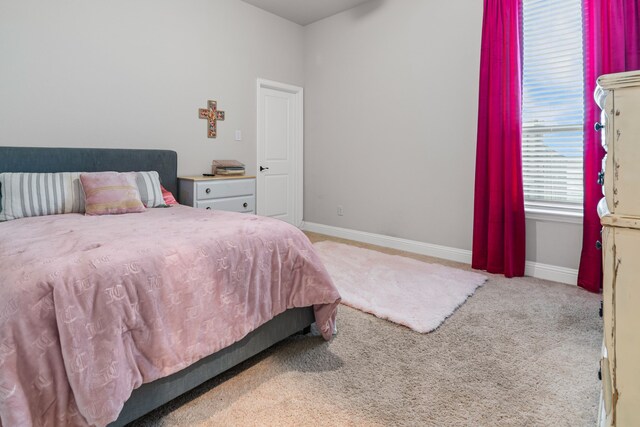 bedroom featuring carpet and baseboards