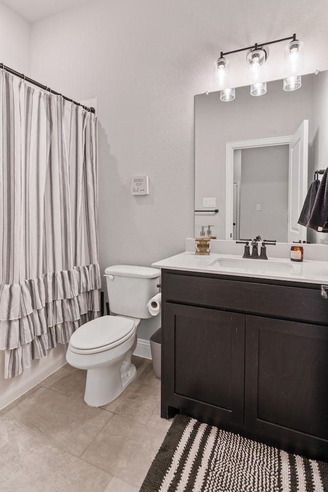 full bathroom featuring toilet, vanity, tile patterned floors, and shower / bath combo with shower curtain