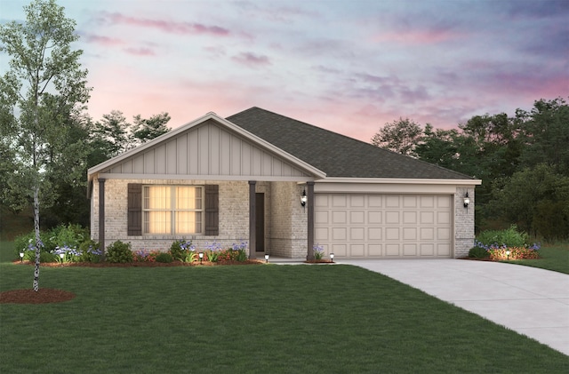 view of front of property with a garage and a yard