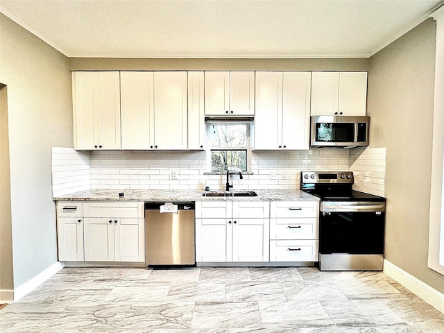 kitchen with light stone countertops, sink, white cabinets, and appliances with stainless steel finishes