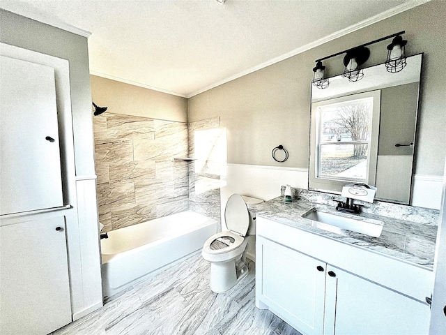 full bathroom featuring crown molding, vanity, tiled shower / bath combo, and toilet